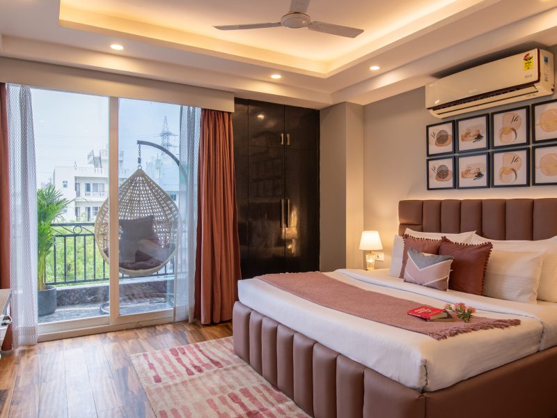 Spacious bedroom with balcony in 2 BHK at Bedchambers Service Apartment Sector 38 Gurgaon