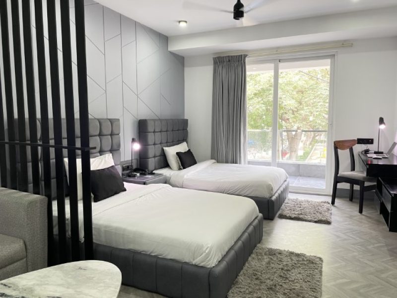 Twin Bedroom with Two Beds and Balcony entrance gate, service apartment in gurgaon
