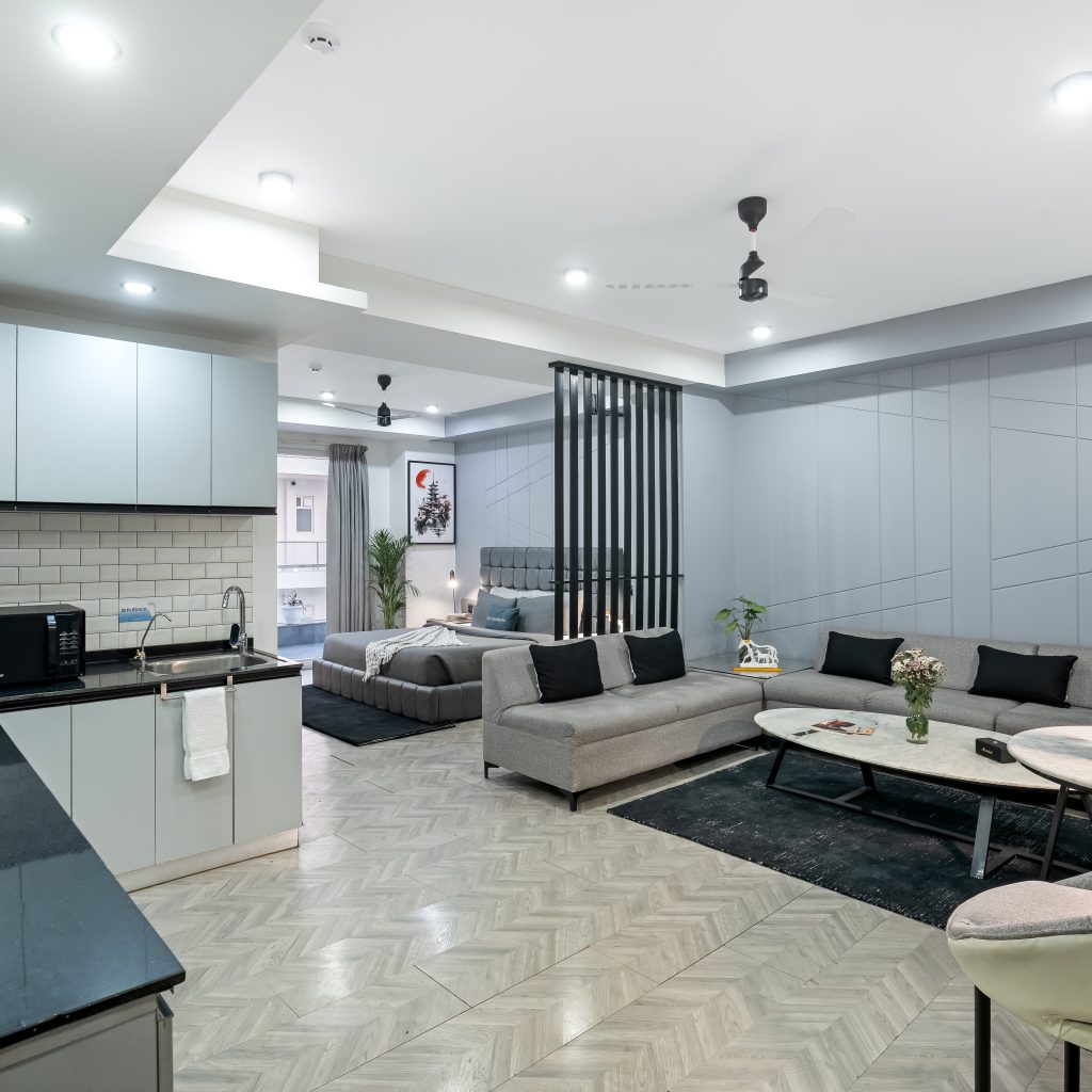 Wide View Living Area with Balcony View, sofas and bed visibile - Service apartment in gurgaon, Mg Road