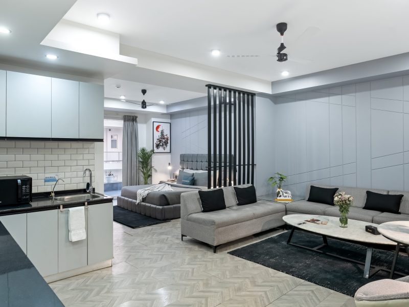 Wide View Living Area with Balcony View, sofas and bed visibile - Service apartment in gurgaon, Mg Road