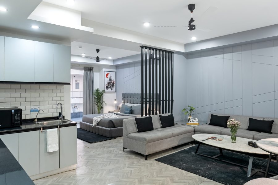 Wide View Living Area with Balcony View, sofas and bed visibile - Service apartment in gurgaon, Mg Road